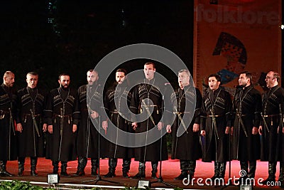 Traditional Georgian male choir performing on stage Editorial Stock Photo
